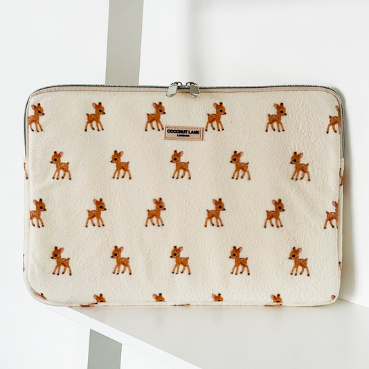 Beige fleece laptop sleeve with a pattern of small brown deer on a white background.