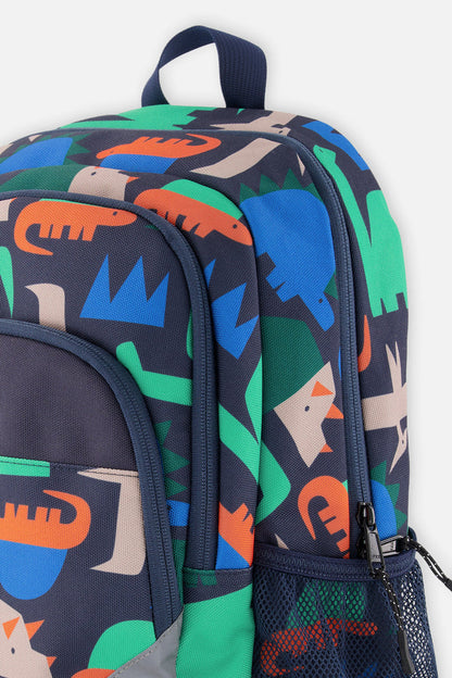 Closeup of Navy dinosaur backpack with printed compartments, side pocket, and zipper detail.