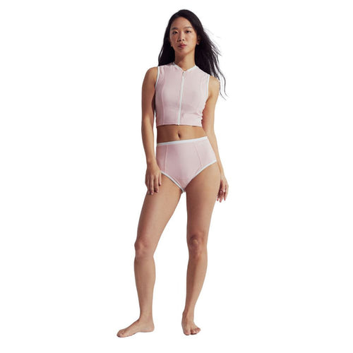 Woman wearing a pink Speedo Wavechasers 2.0 crop zip vest with white trim and a front zipper.