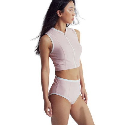Woman in light pink Speedo Wavechasers 2.0 high-waisted swim bottom with white trim.