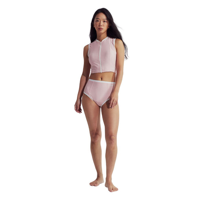 Woman in pink Speedo Wavechasers 2.0 crop zip vest with white trim and matching high-waisted bottoms.