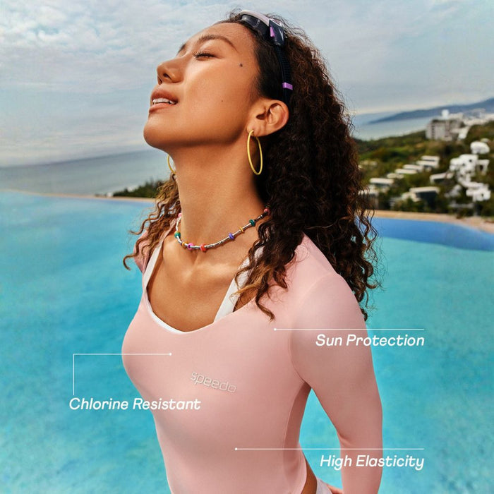 Woman in a pink Speedo Wavechasers 2.0 crop zip vest, highlighting sun protection, chlorine resistance, and high elasticity.