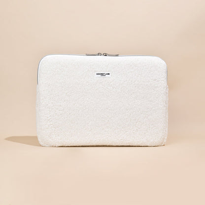 White fluffy Coconut Lane laptop sleeve with zip closure.