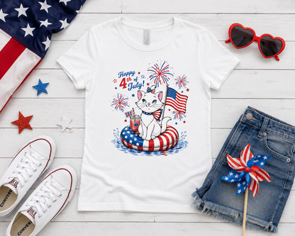 White t-shirt with 4th of July design featuring a cat, surrounded by American flag, sunglasses, denim shorts, and Converse shoes on a wooden surface. USA 250